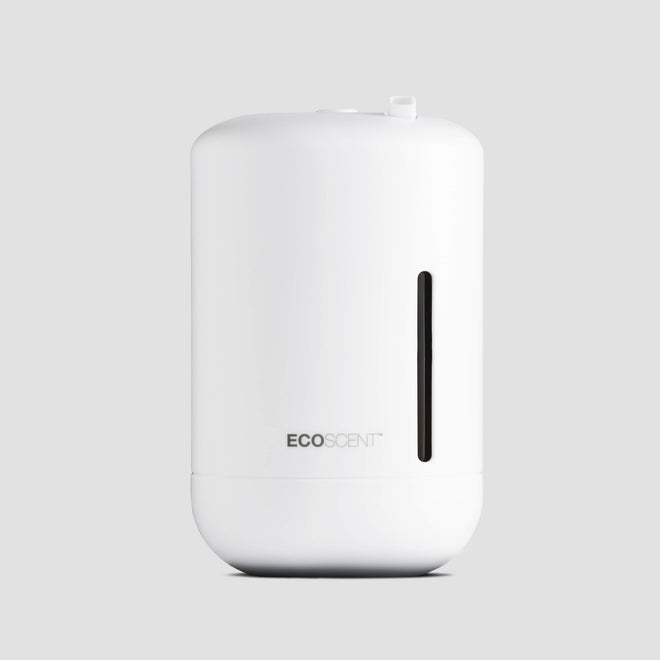EcoScent Ariel wall-mounted scent machine in white, designed for small commercial spaces and bathrooms up to 100m³, featuring a sleek cylindrical body and a visible fragrance output window.
