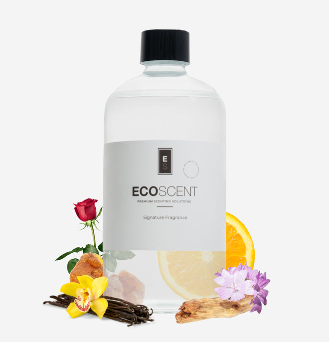 Ecoscent-shop Orange, Bergamot & Patchouli Fragrance Oil in a clear bottle with a black cap, surrounded by flowers, vanilla pods, and citrus slices, showcasing the signature fragrance design.