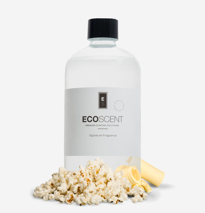 Ecoscent-shop Popcorn Fragrance Oil in a clear bottle with a black cap, featuring a blend of butter, corn, and vanilla scents, displayed with popcorn kernels and a piece of butter.