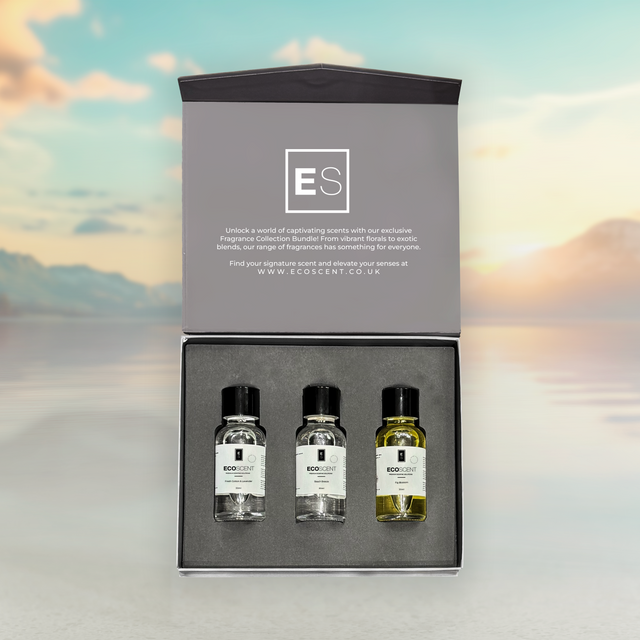 Three small bottles with labels inside a gray box against a blurred sky background