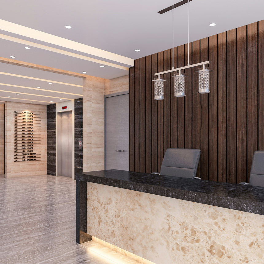 Modern lobby reception area with a marble-topped front desk, two gray chairs, a wood slat accent wall, and warm recessed lighting.