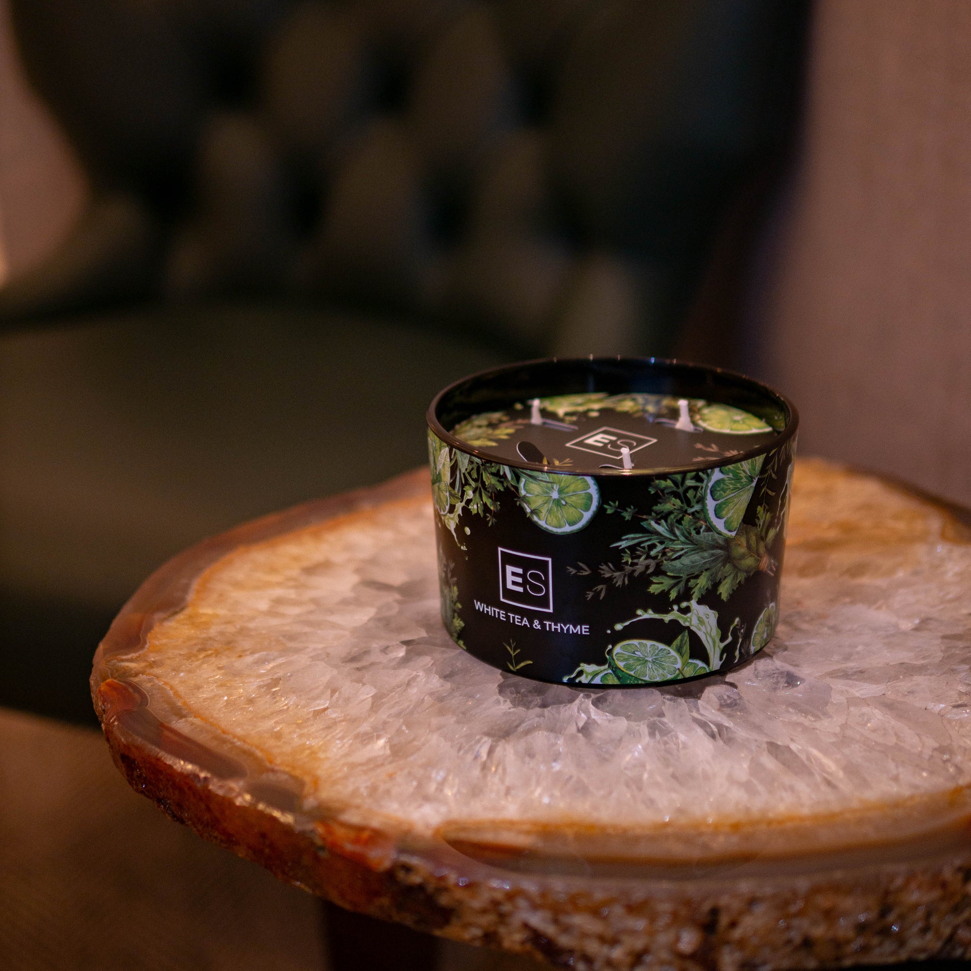 Candle with decorative packaging on a wooden table