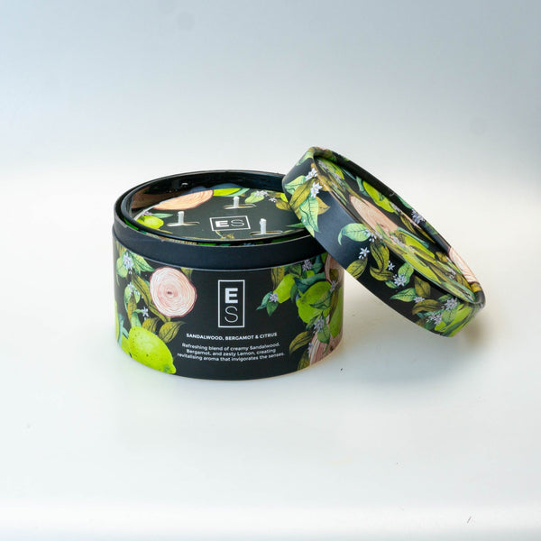 Decorative candle with floral design on a white surface