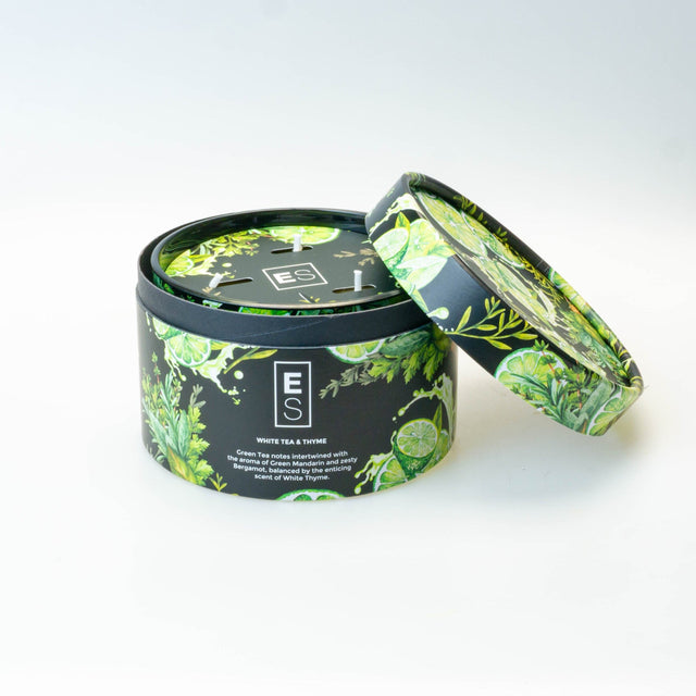 Tea canister with green leaf design on a white background