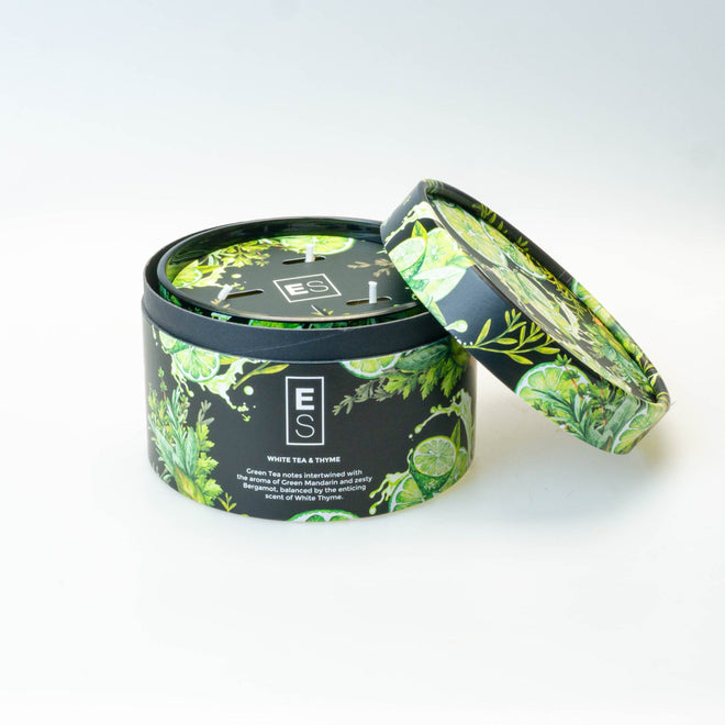 Tea canister with green leaf design on a white background