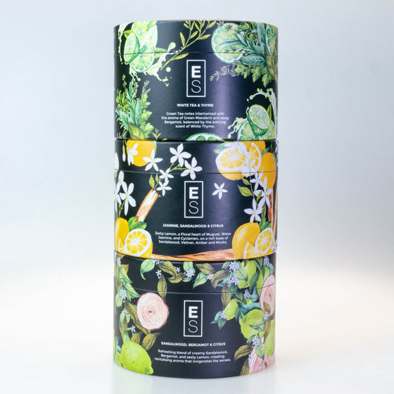 candle packaging with floral and fruit designs on a white background