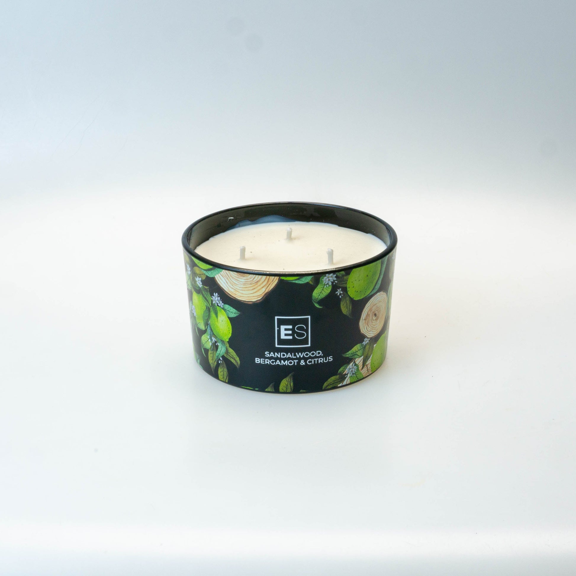 Candle with a decorative label on a white surface
