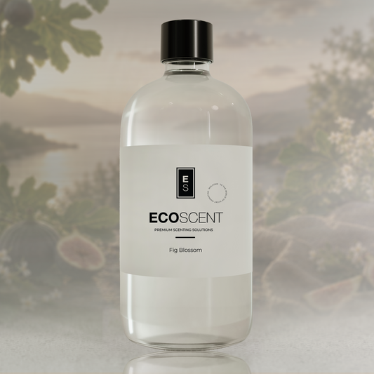 A clear bottle of EcoScent Fig Blossom premium scenting solutions with a white label and black cap, set against a soft-focus background of green leaves and water.