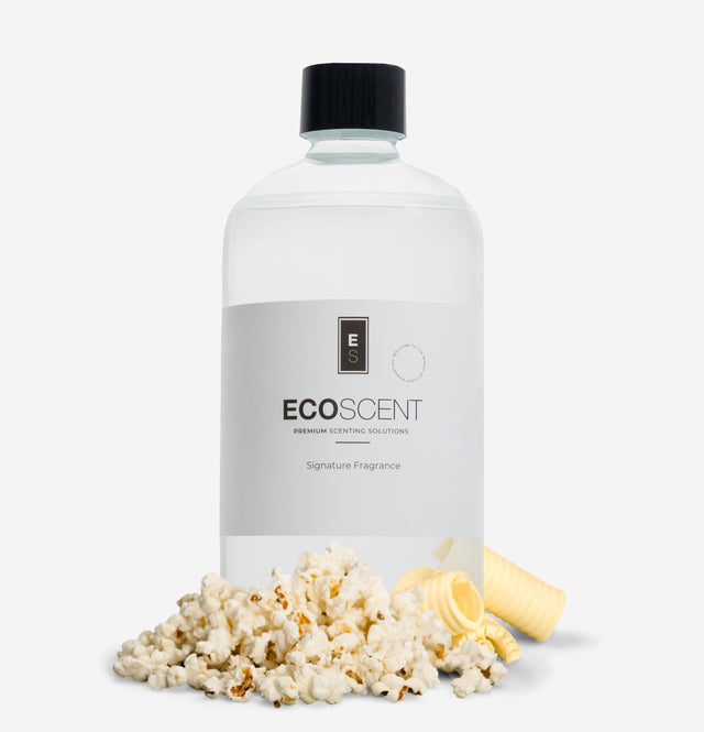 Ecoscent-shop Popcorn Fragrance Oil in a clear bottle with a black cap, featuring a blend of butter, corn, and vanilla scents, displayed with popcorn kernels and a piece of butter.