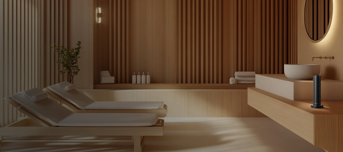 A modern spa interior with a scent machine, wooden accents, white lounge chairs, towels, and toiletries, creating a serene ambiance for relaxation and wellness treatments.
