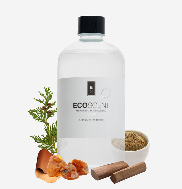 ecoscent-shop Tuscan Leather Fragrance Oil, featuring notes of leather, sandalwood, and amber. The clear bottle is labeled with the brand logo and surrounded by natural elements including wood and resin for visual context.