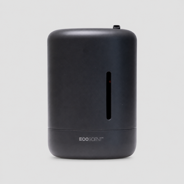 A matte black EcoScent portable diffuser with a vertical slot on the front, shown against a light gray background.