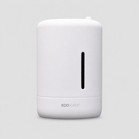 A white cylindrical EcoScent diffuser with a vertical black window on the front and the EcoScent brand name printed near the base, set against a solid light gray background.