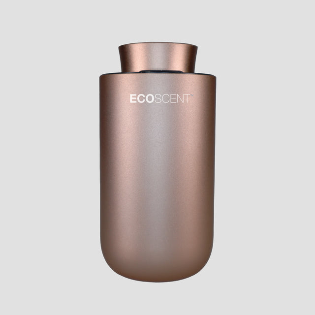 EcoScent Premium Scent Solutions EcoScent Puck – Battery Portable Scent Machine in a sleek metallic rose gold finish, designed for cars, bathrooms, and small spaces up to 100m³.