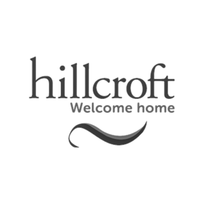 A gray graphic logo on a white background featuring the text 'hillcroft' in a serif font, 'Welcome home' underneath, and a curved decorative line below.