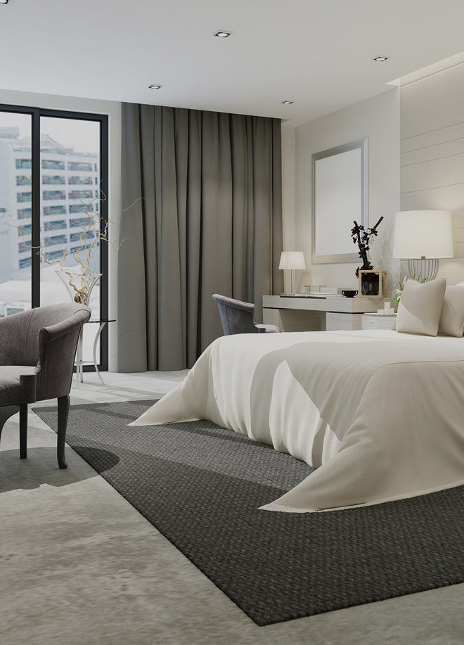A luxurious hotel room with a large bed, tester cards with scents displayed on a table, and floor-to-ceiling windows with a city view.